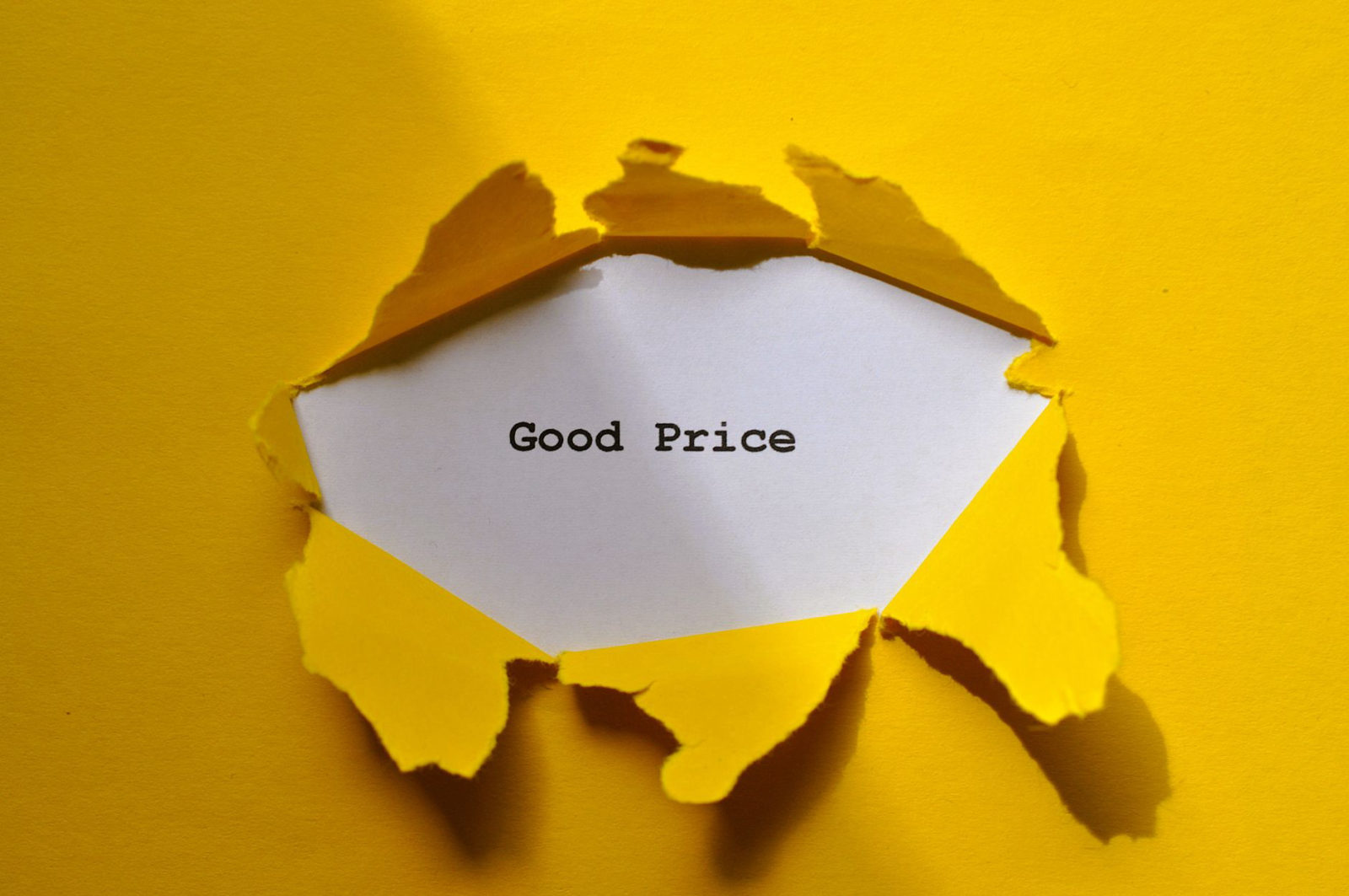 Torn yellow paper revealing the words Good Price underneath, illustrating how much does CTV advertising cost for local businesses