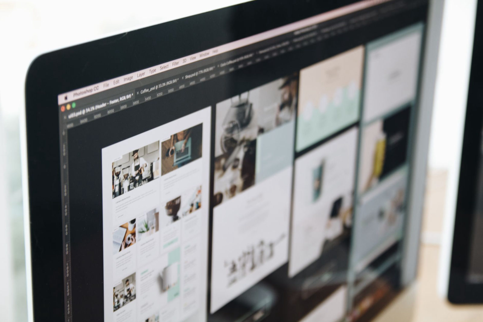 A close-up of a designer's monitor displaying a clean, modern website layout grid — representing affordable small business website design pricing in the Santa Clarita Valley