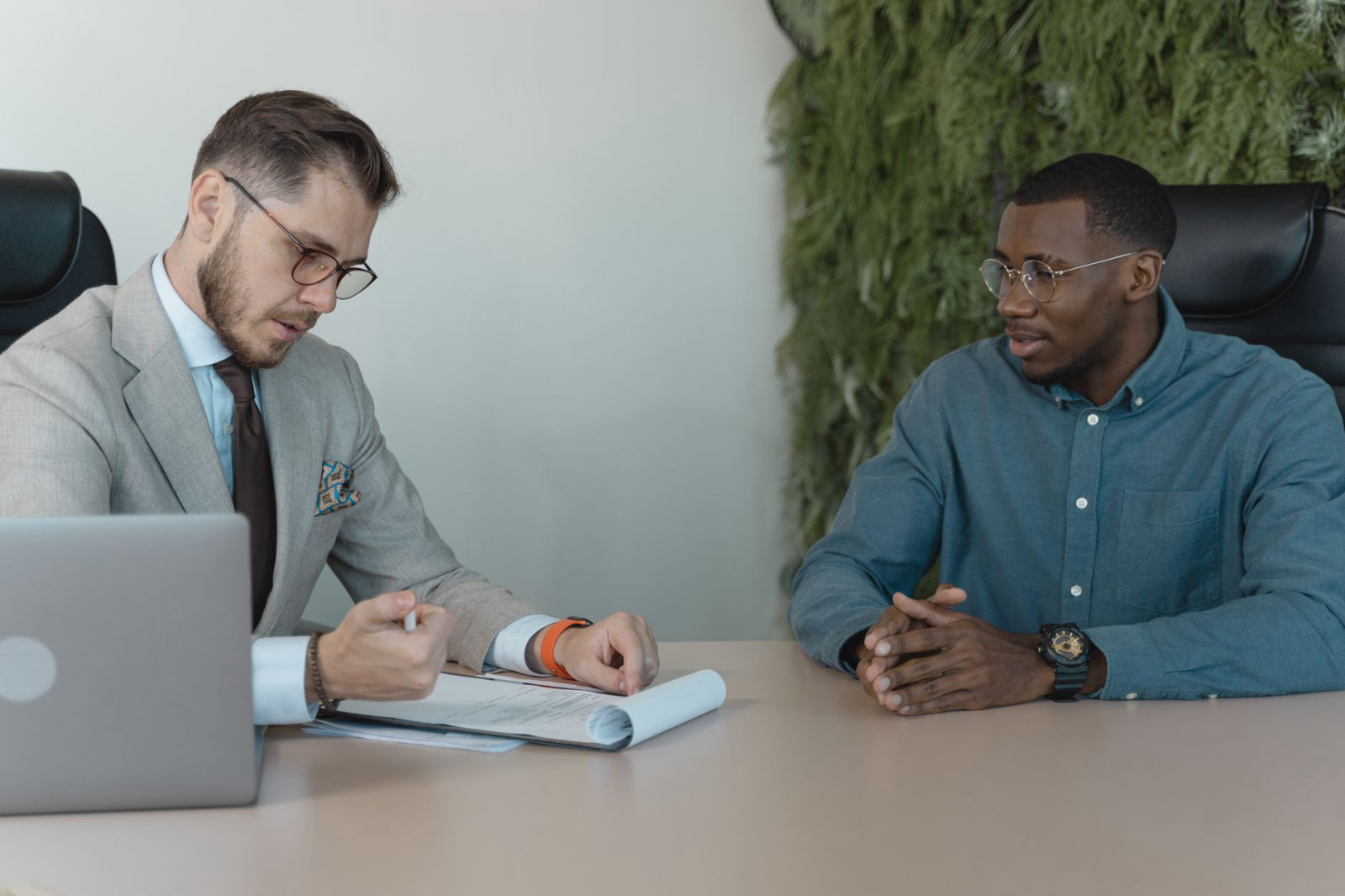 Two professionals in a meeting discussing strategy, illustrating when to hire a marketing consultant to drive business growth