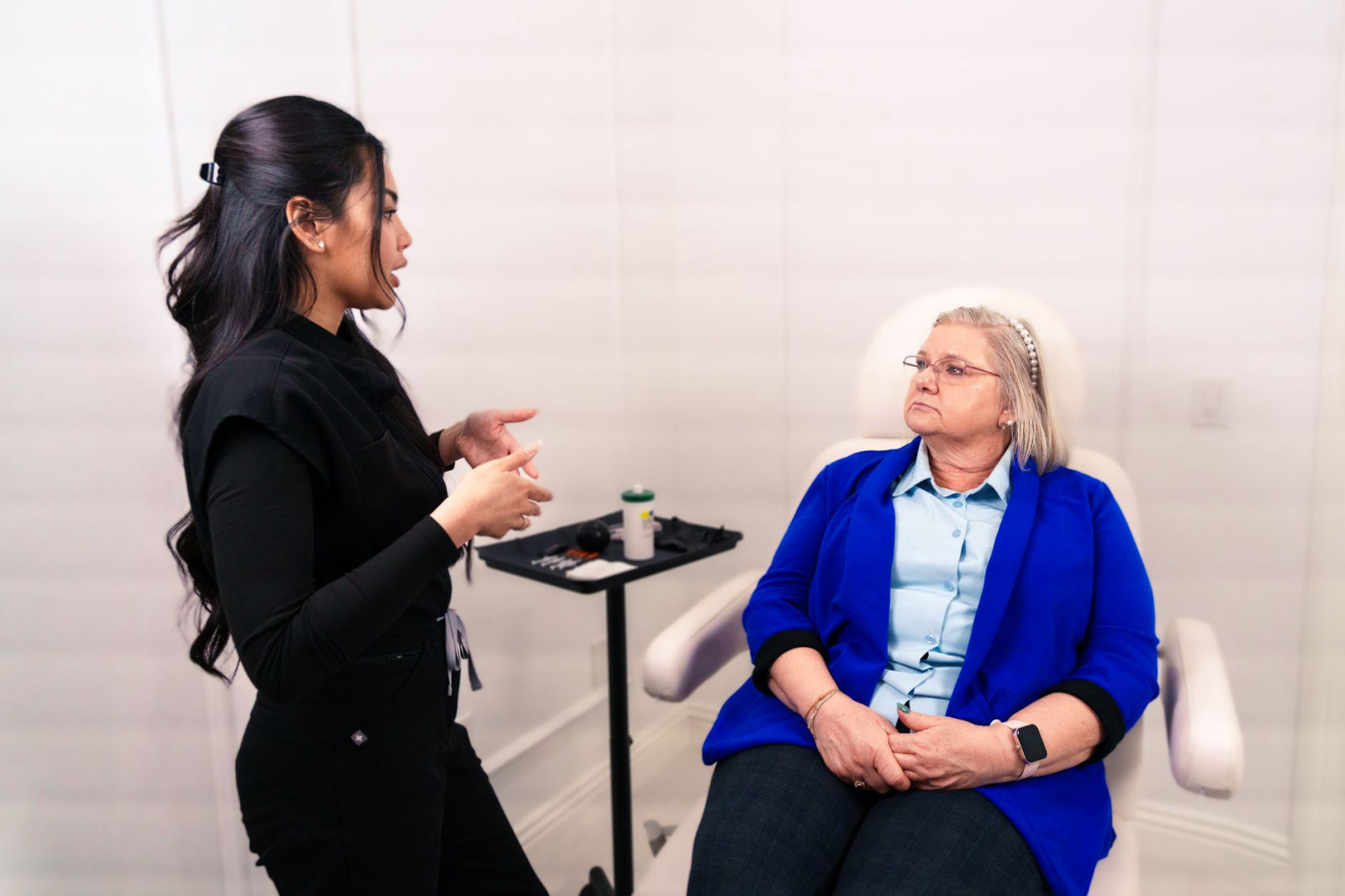 A med spa specialist consulting with a client in a modern treatment room — illustrating how to market a med spa in Santa Clarita CA to get more bookings through personalized client experiences