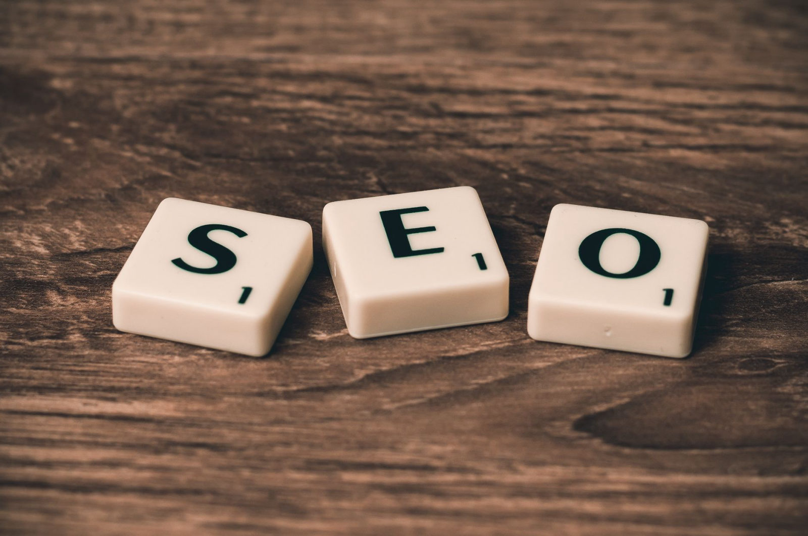 Scrabble tiles spelling SEO on a wooden surface, illustrating how to resell white label SEO services under my own agency brand